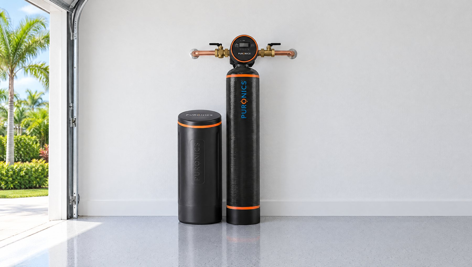 Puronics Defender iGen water softener with its brine tank in a clean Florida garage, plumbed into the main line on the wall behind it