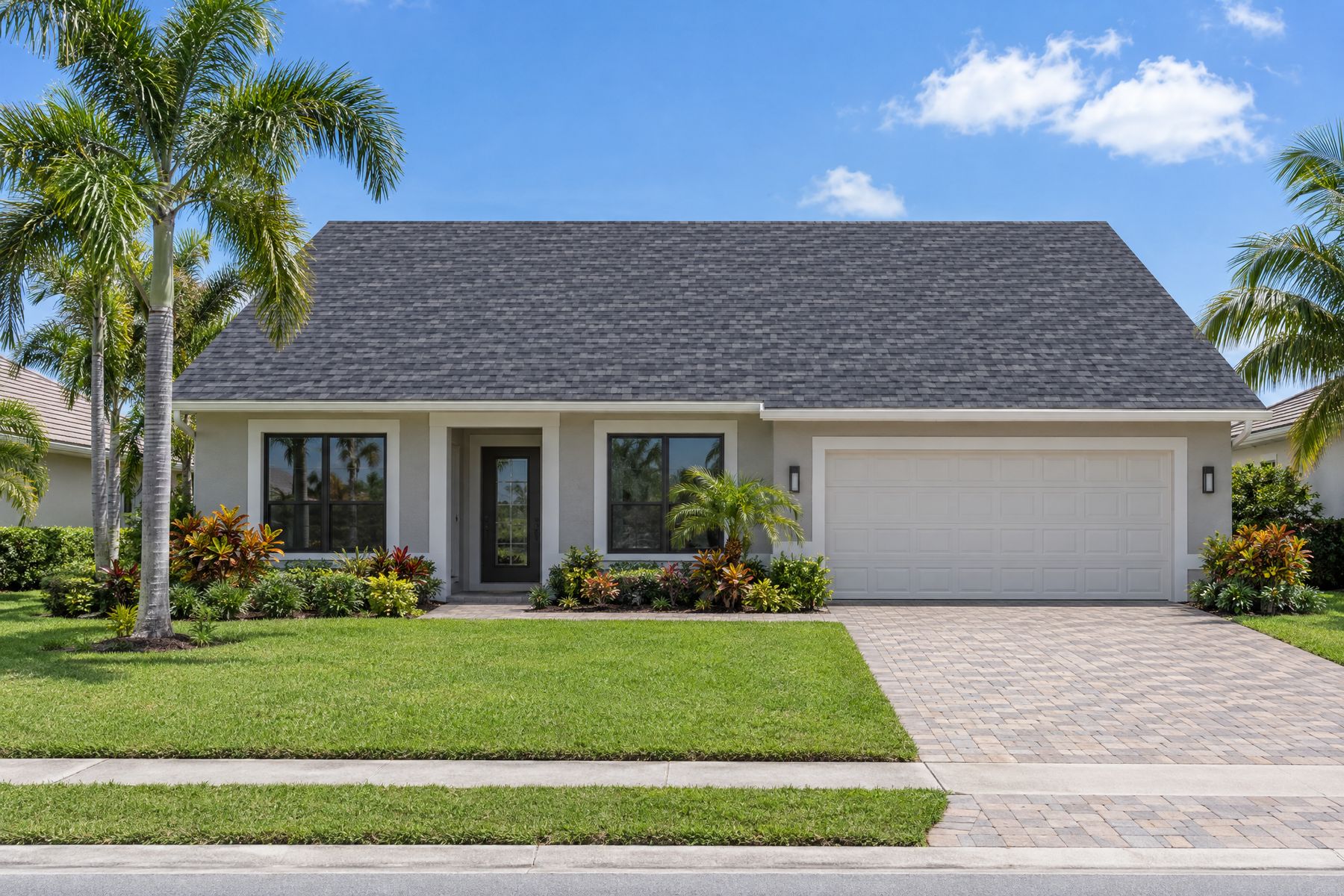 A single-story Florida home with a charcoal architectural shingle hip roof and no solar