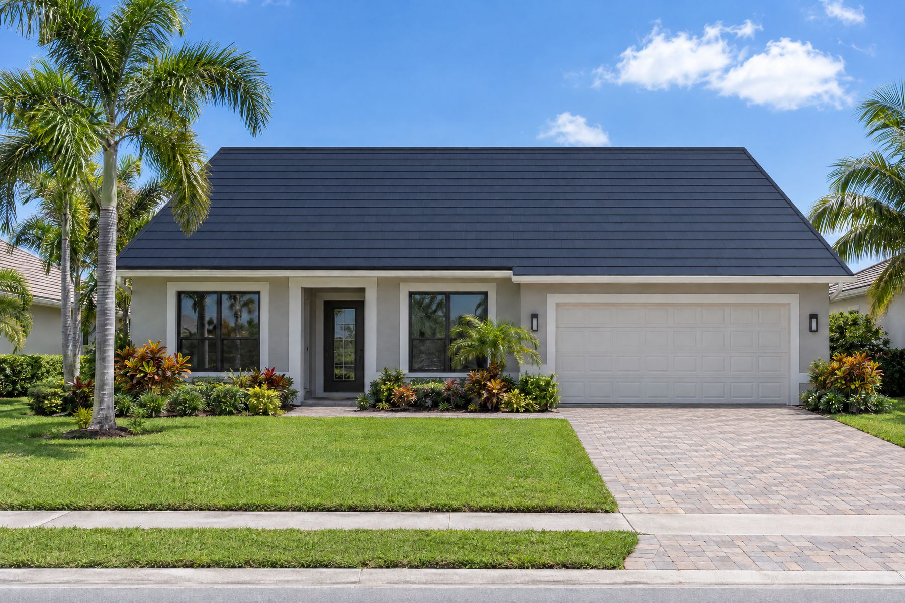 The same home with its whole roof covered in dark blue-black solar shingles, with no separate panels