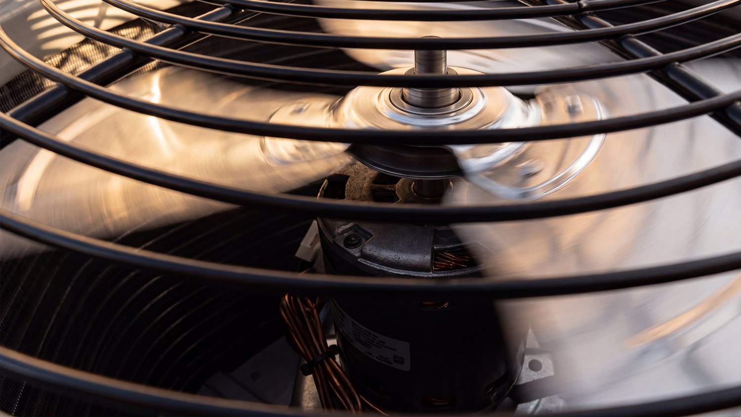 Close-up of an outdoor air conditioning condenser fan at a home in Daytona Beach